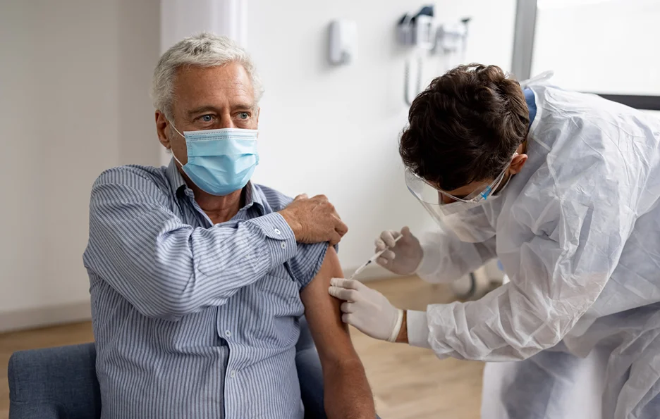 an elderly man had vaccination inside a clinic