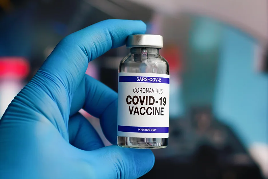 Medical provider holding a vial of coronavirus vaccine