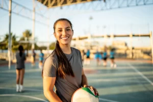 a young woman playing vollerball along with her team
