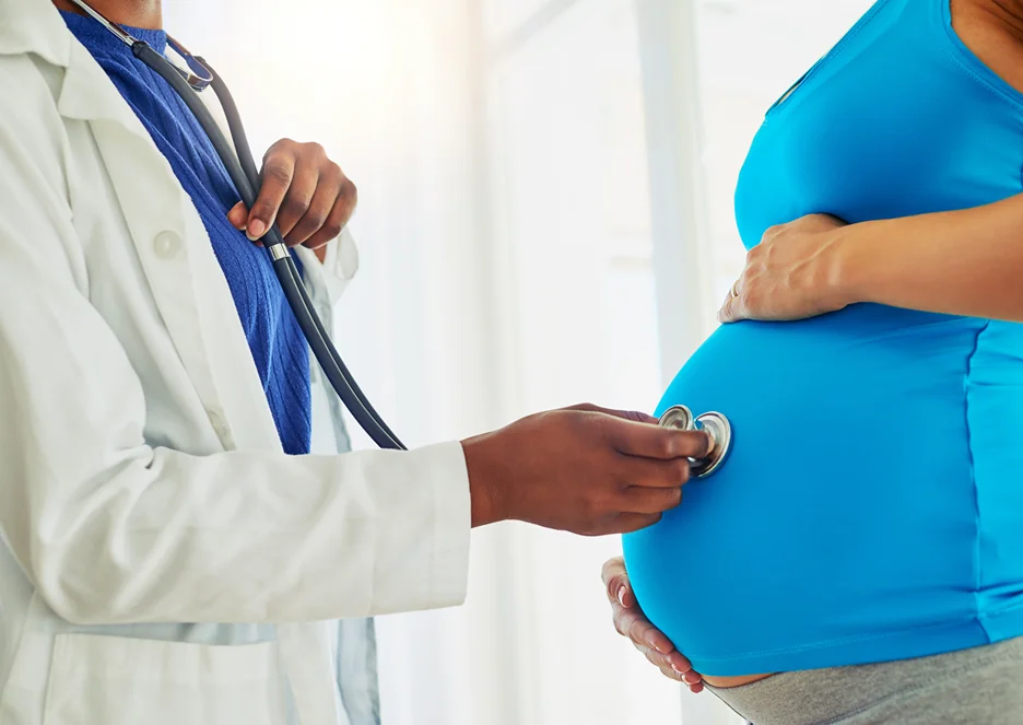 a doctor checks the pregnant woman