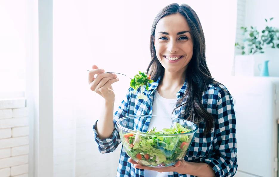 a woman eating salad